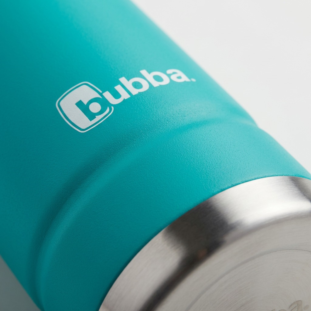 Extreme close-up of the textured turquoise body meeting the polished stainless steel base on a bubba bottle.