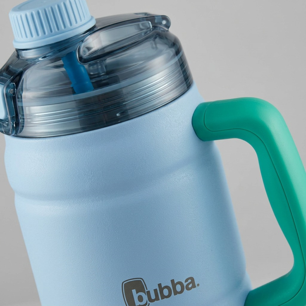 Extreme close-up of bubba water keg showing lid seal, straw connector, and handle junction details.
