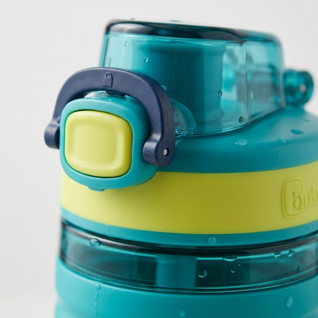 Macro view of the bubba Flo lid, showing the dark navy latch, lime-yellow button, and textures.