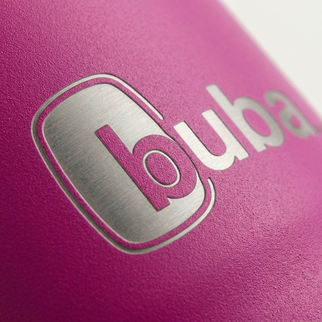 Extreme macro of the laser-etched bubba logo on textured magenta steel of the Hero XL tumbler.